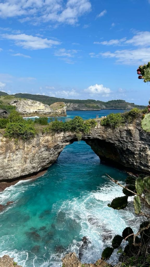 Broken Beach Nusa Penida with natural coral arches and blue sea views.
