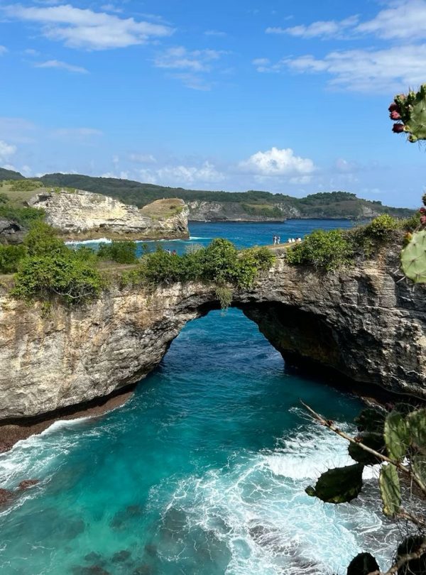 Broken Beach Nusa Penida with natural coral arches and blue sea views.