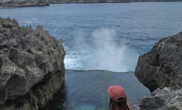 Angel's Billabong Nusa Penida with a natural pool of clear water between the coral cliffs.